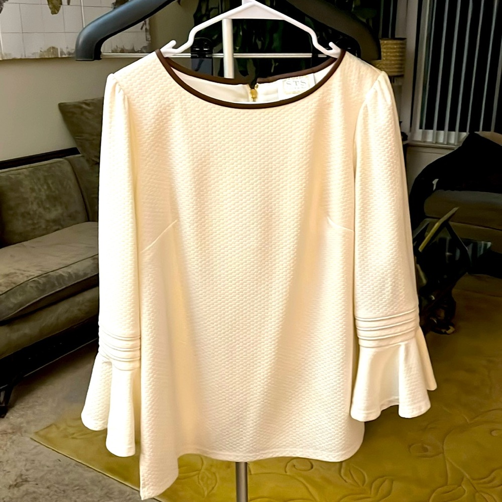 Ladies cream color top with brown trim and long sleeve with ruffle!